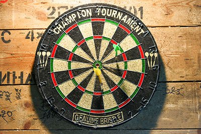 Why does a dartboard wear out?